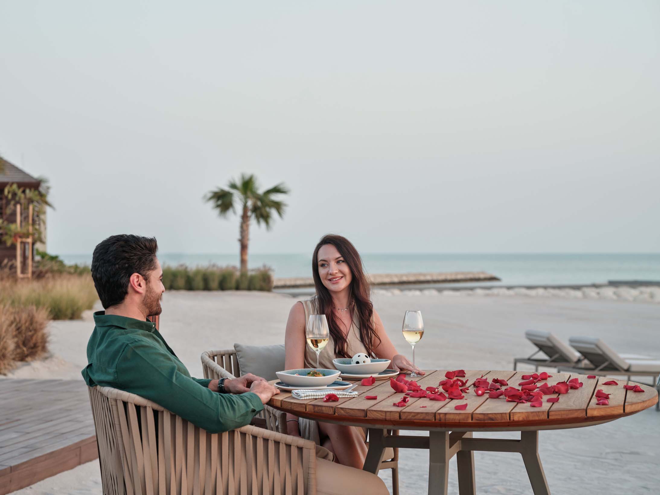 A couple enjoying dinner on the beach