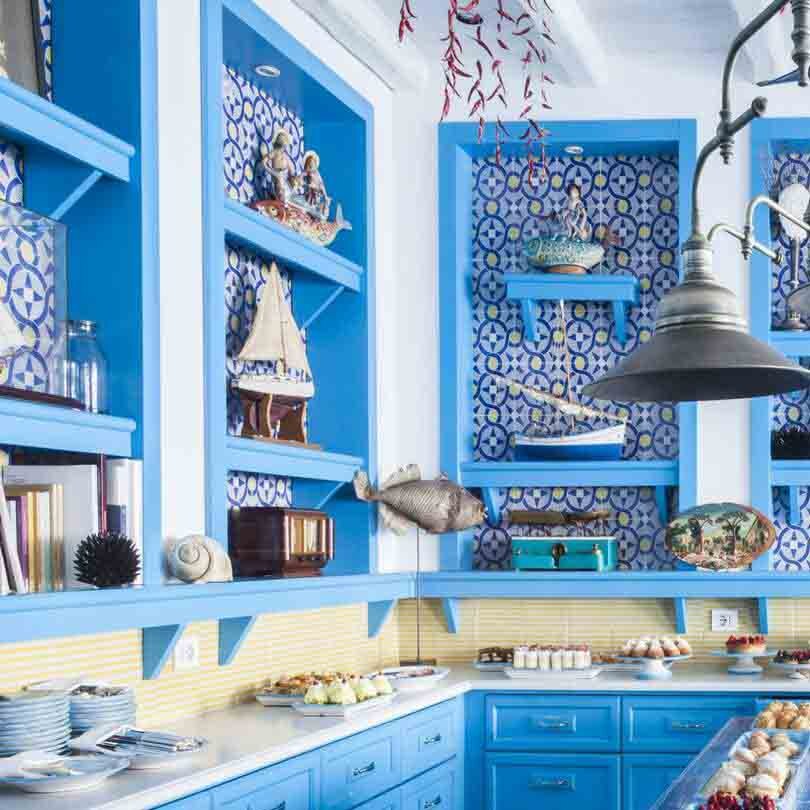 Blue kitchen with colourful dishes.