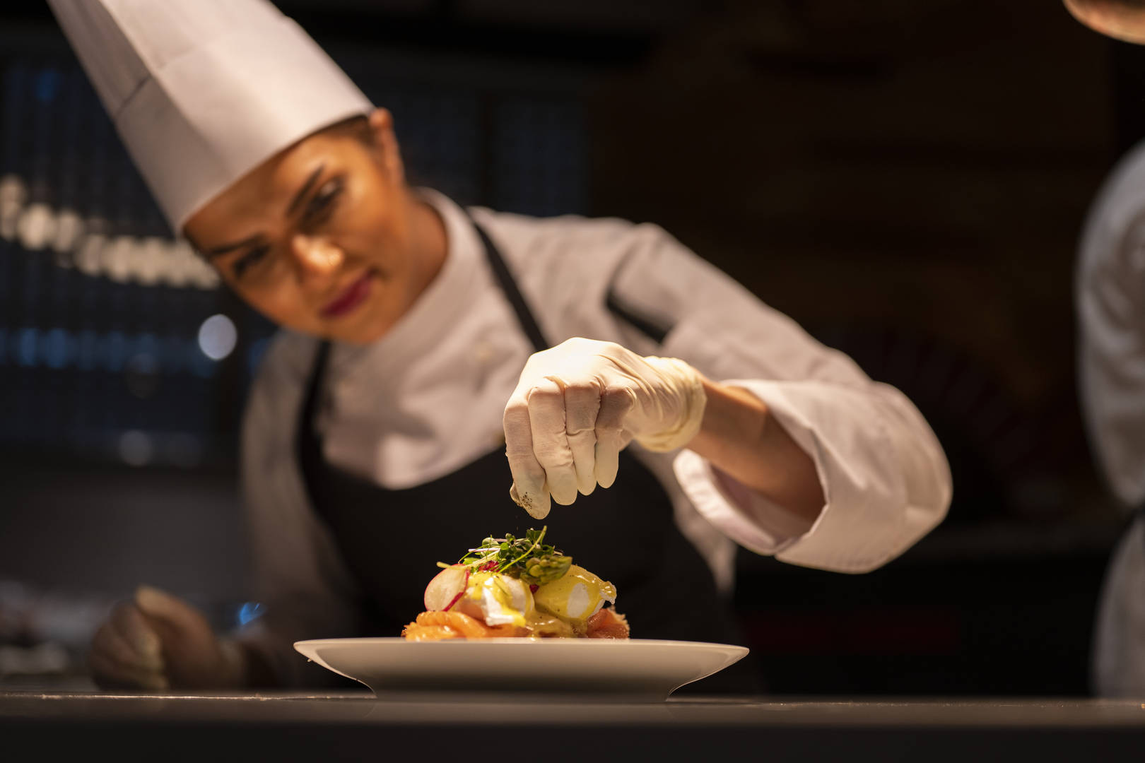 Dish garnishing by female chef at Jumeirah Hotels and Resorts