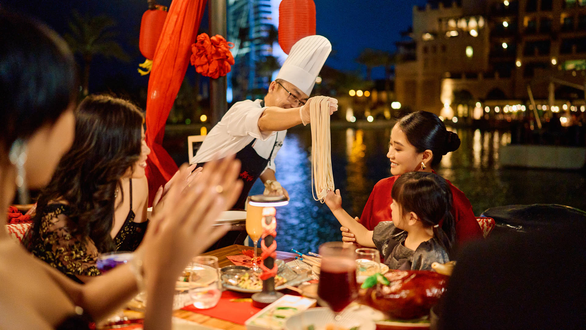 Family celebrating Chinese New Year at Jumeirah Mina A'Salam