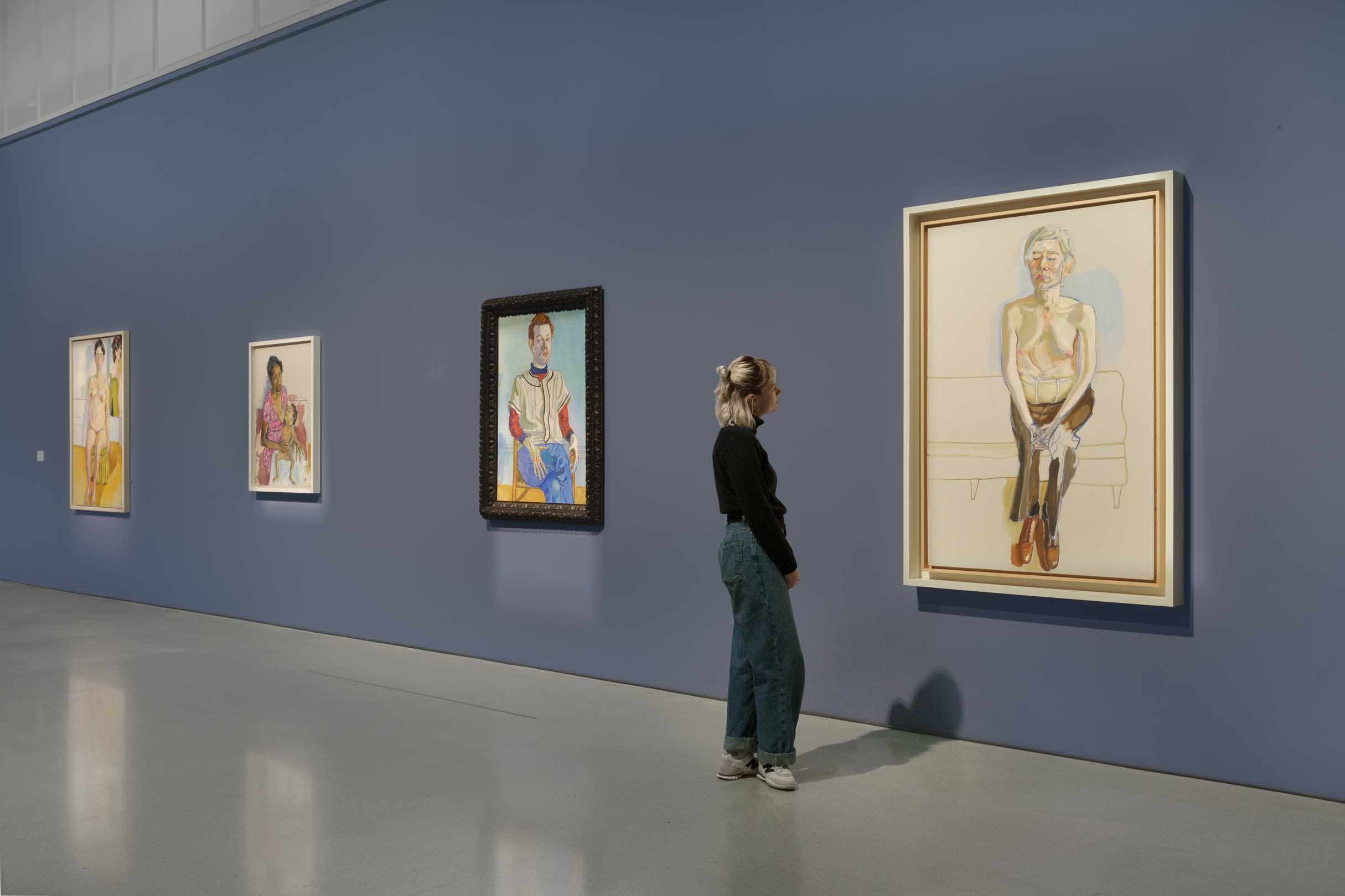 A visitor enjoying the Barbican's Alice Neel exhibition in 2023