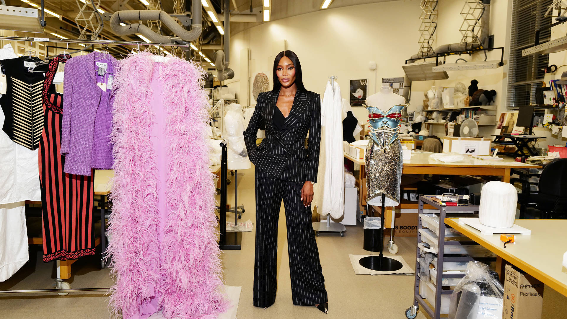 Supermodel Naomi Campbell standing with archive runway looks