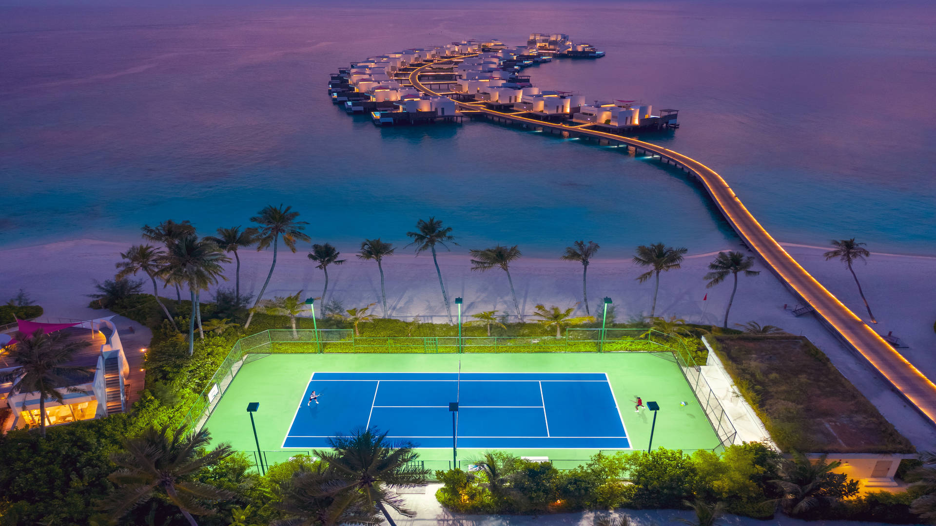 Tennis court by the ocean at Jumeirah Maldives Olhahali Island