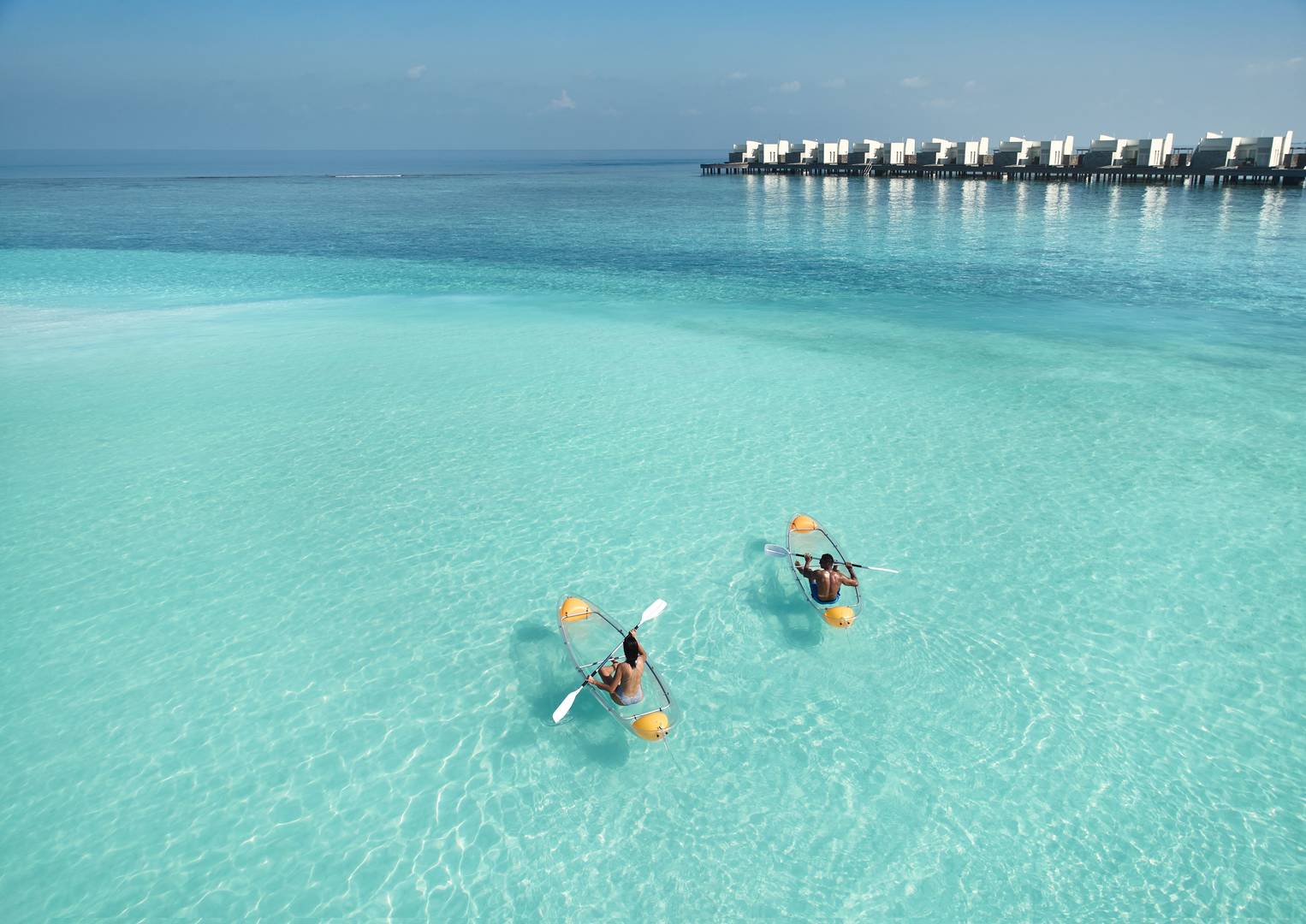 https://cdn.jumeirah.com/-/mediadh/dh/hospitality/jumeirah/article/stories/maldives/soar-and-explore-in-the-maldives/highresolution300dpijumeirah-maldives--island-lagoon-glass-kayak-aerial-view.jpg?h=1080&w=1526