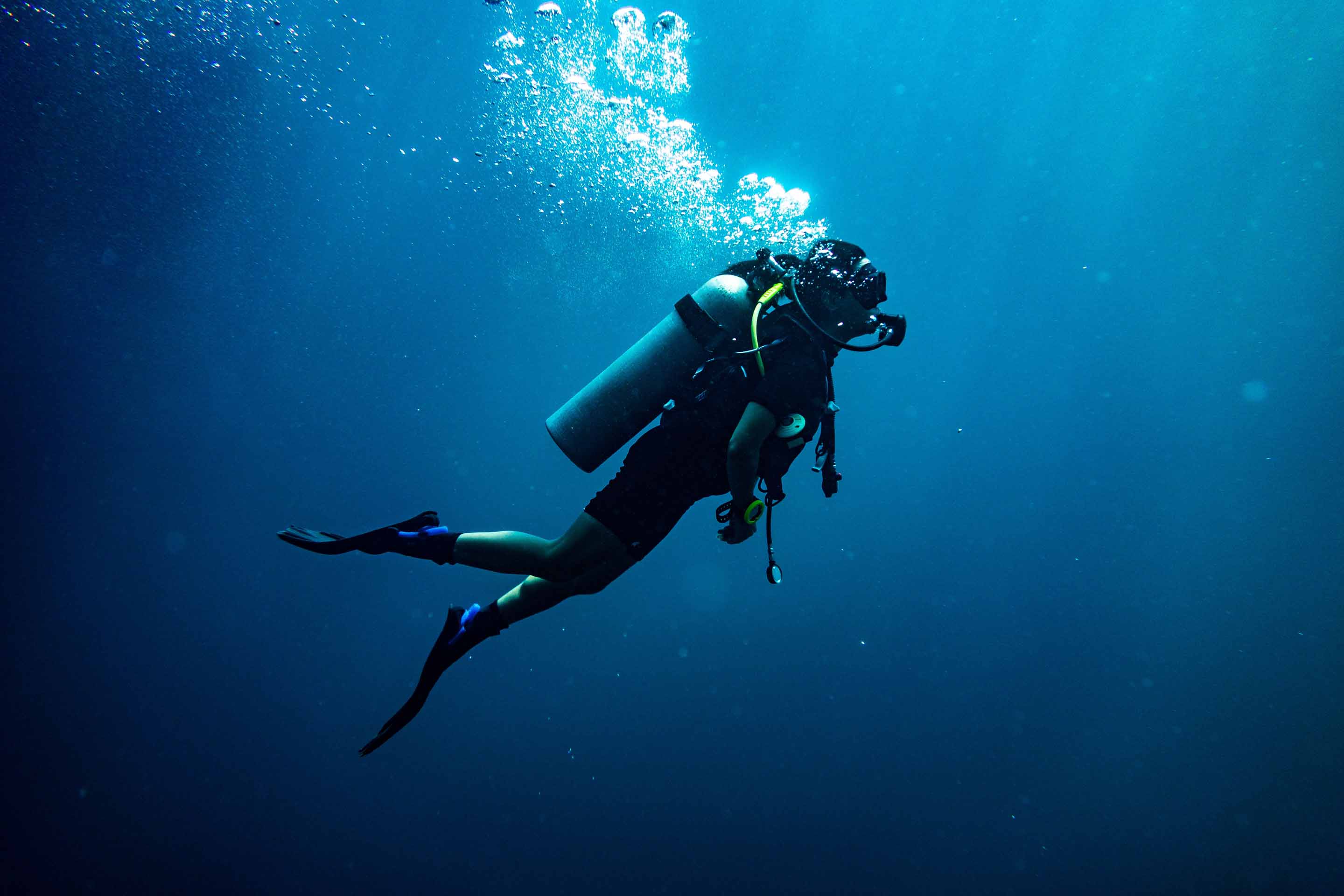 A man going Scuba diving in Muscat Bay