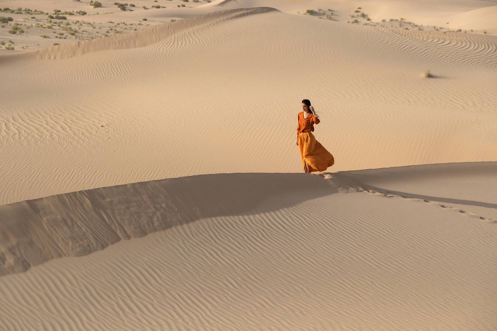 Lady walking on a dune