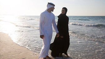 Arabic couple by the beach of Jumeirah at Saadiyat Island Resort