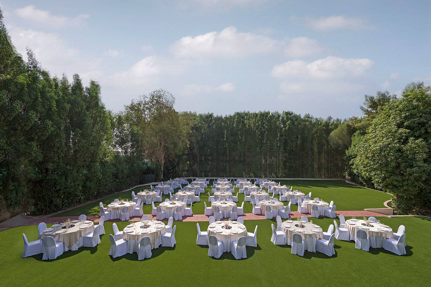 Tables set up on lawn for event at Jumeirah Creekside Hotel