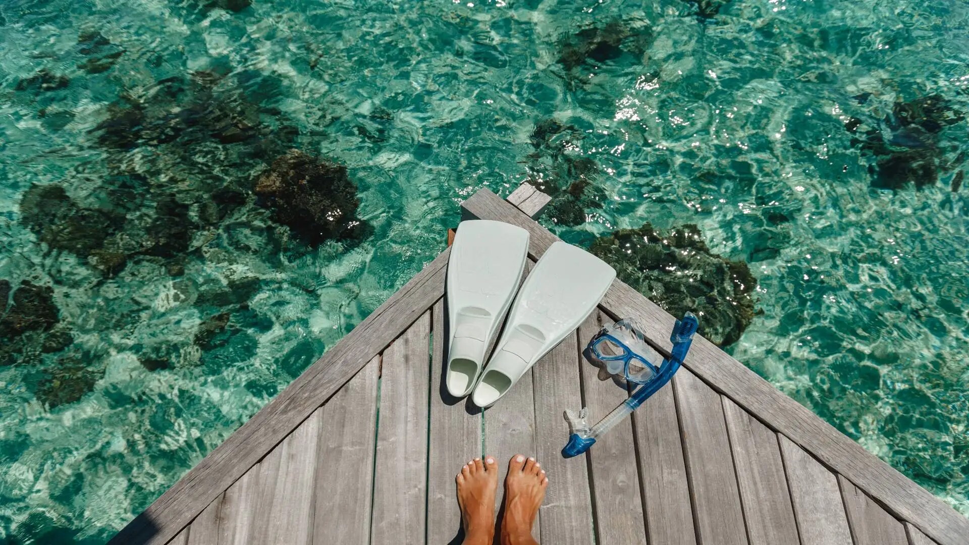 Snorkel and mask on a sun deck in the Maldives