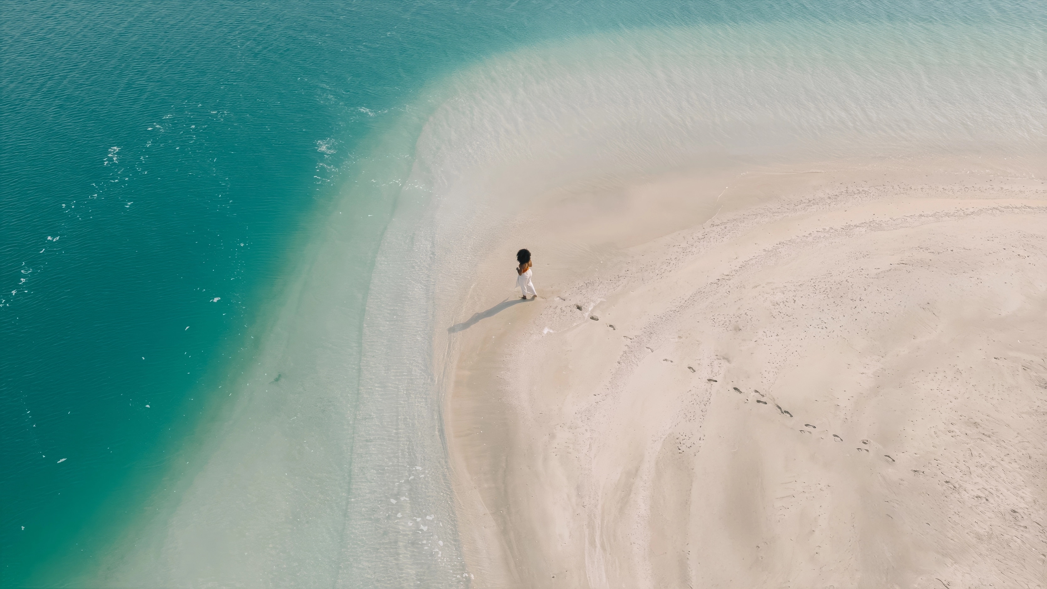 Jumeirah Burj Al Arab_Cape Morris_Lifestyle_Lady on Beach_Sea_Wide Drone.jpg