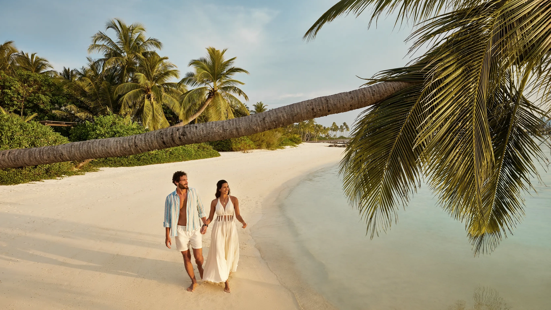 Jumeirah Maldives - Couples walking by the beach 1