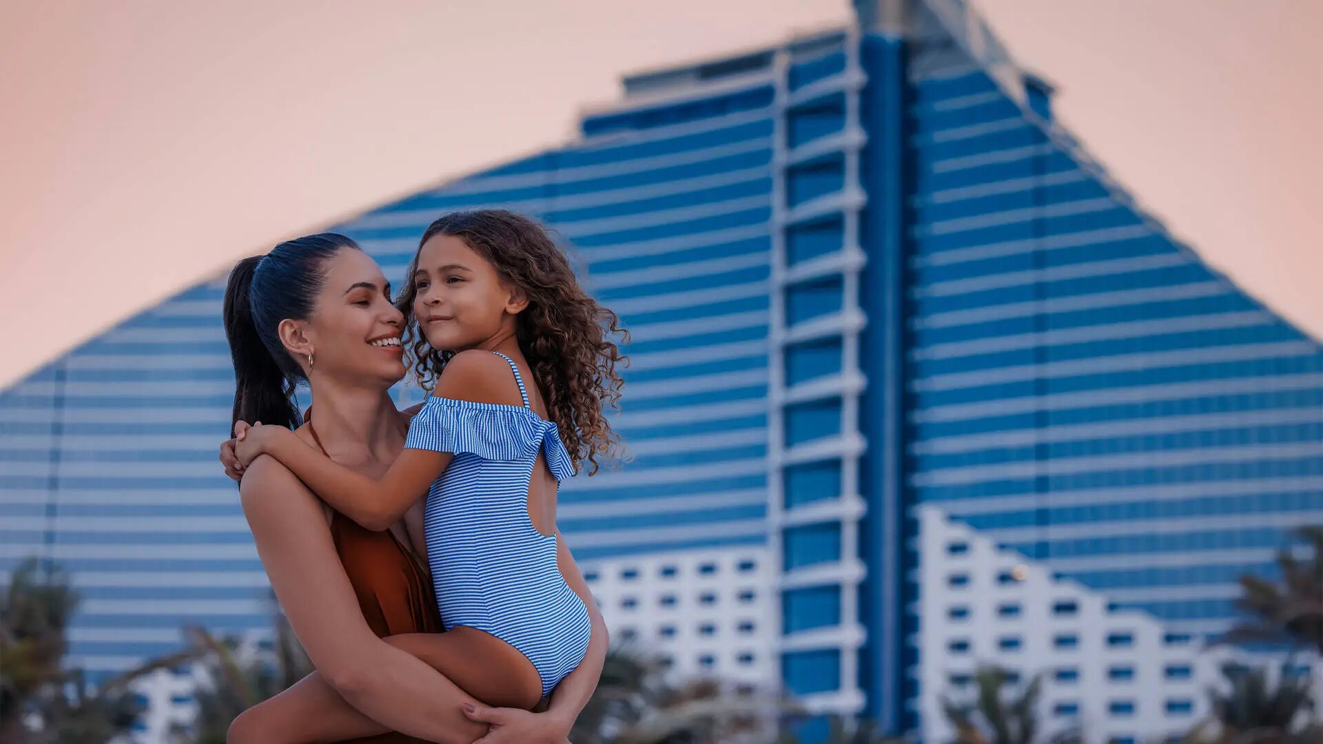Mother and daughter on the beach in front of Jumeirah Beach Hotel