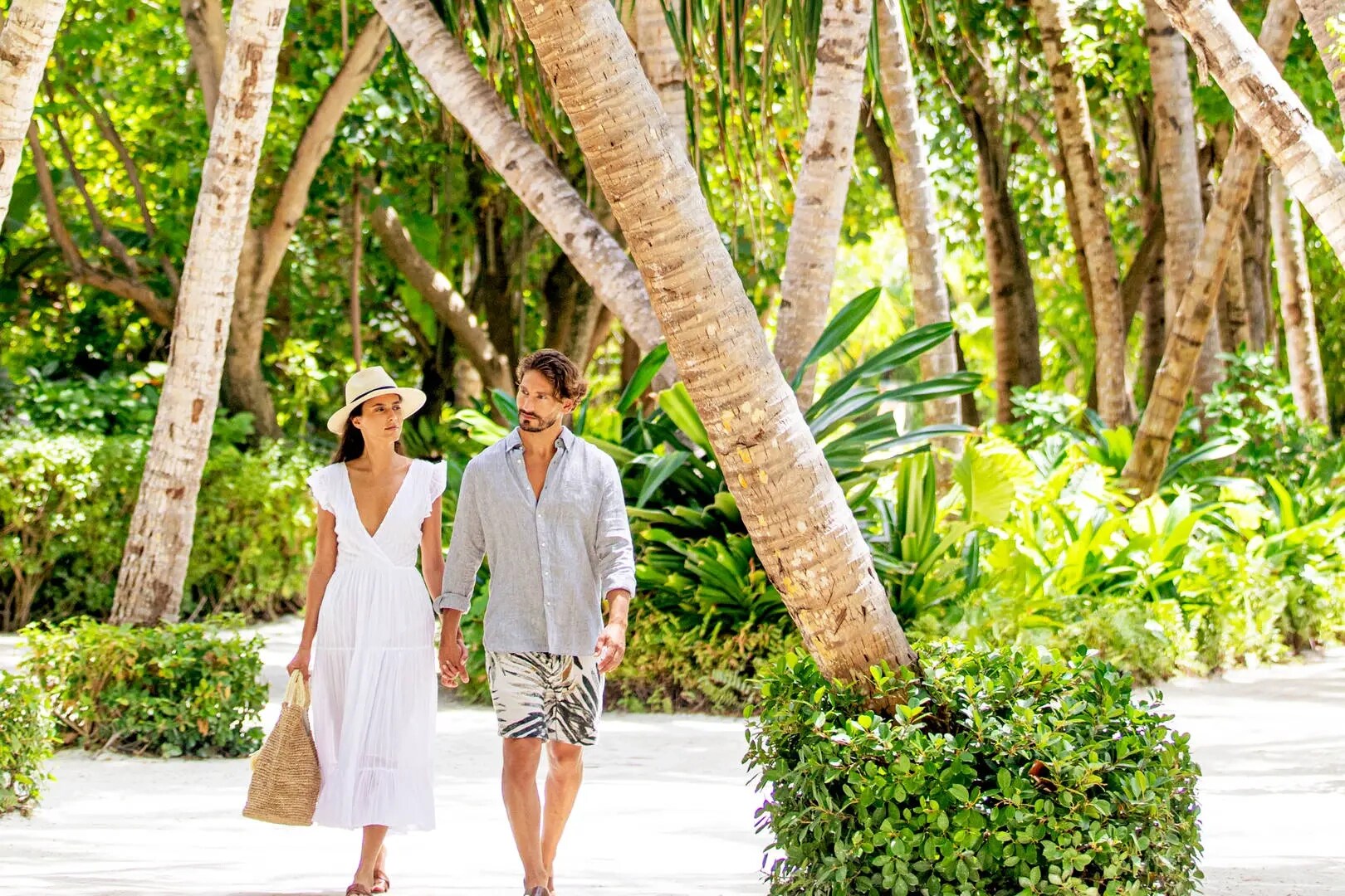 Jumeirah Maldives Ohahali Island couple walking amid greenery