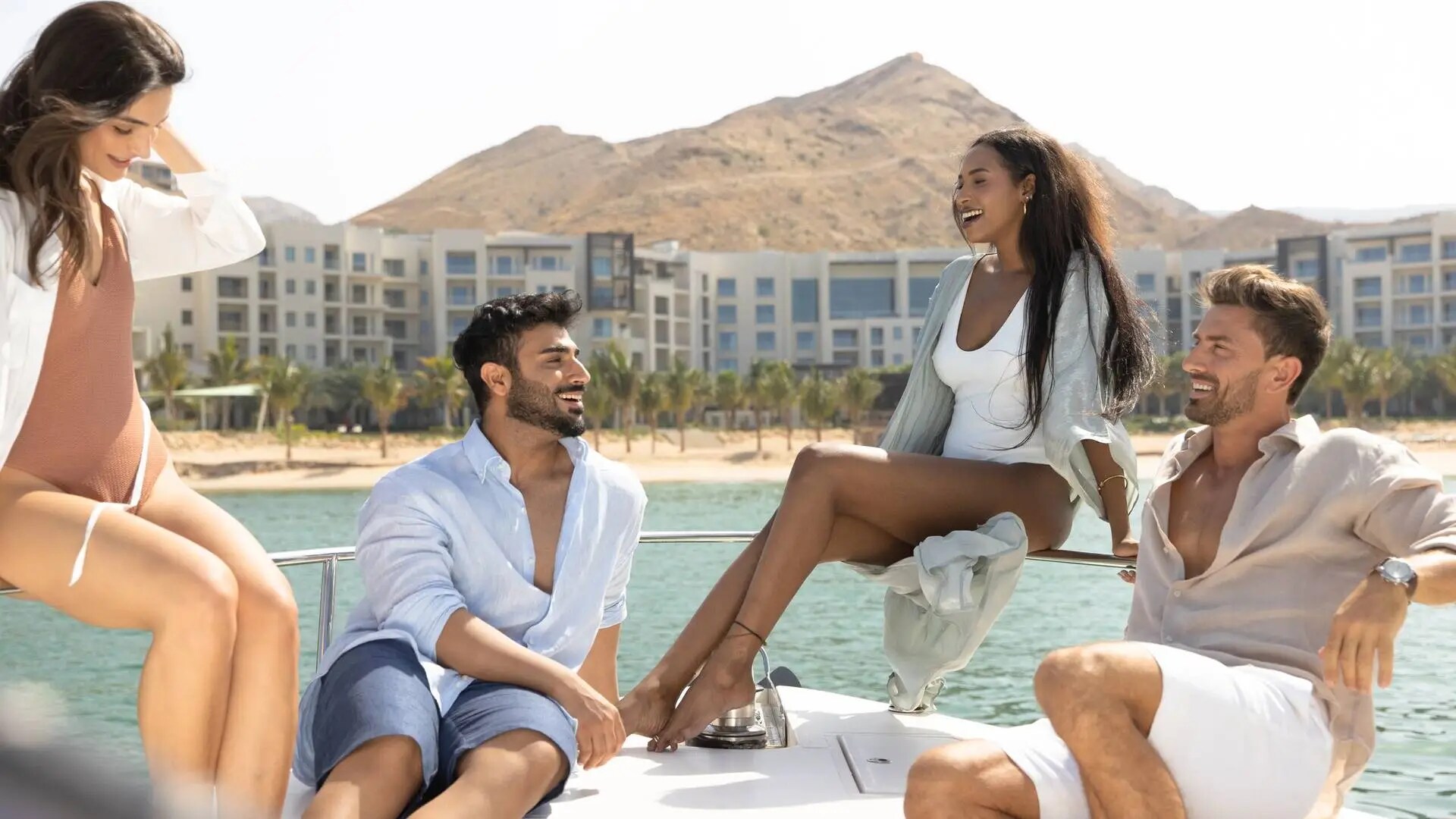 Friends on a boat at Jumeirah Muscat Bay